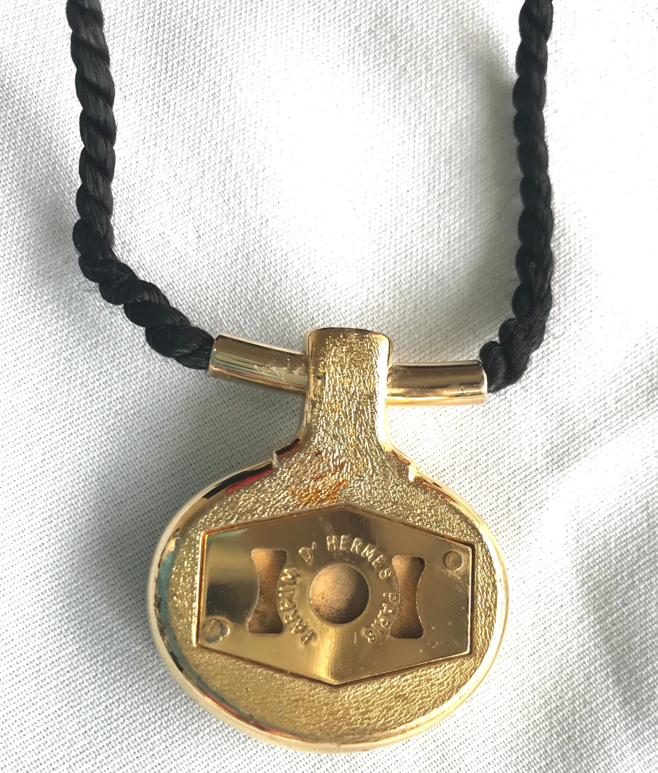 Vintage Hermes golden and red stone charm pendant top necklace with black strings. Unique jewel piece from PARFUM Collection. 060919re1