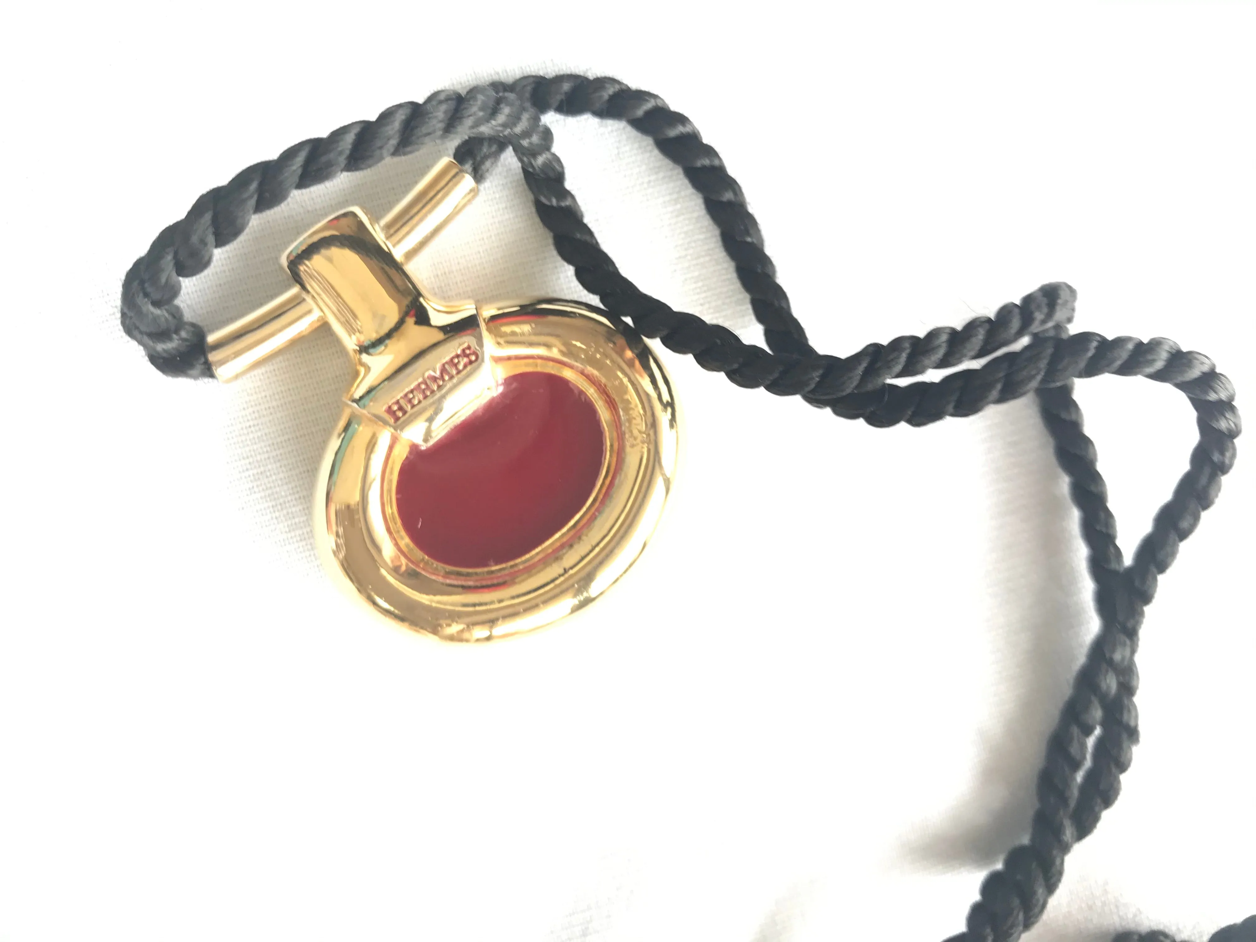 Vintage Hermes golden and red stone charm pendant top necklace with black strings. Unique jewel piece from PARFUM Collection. 060919re1