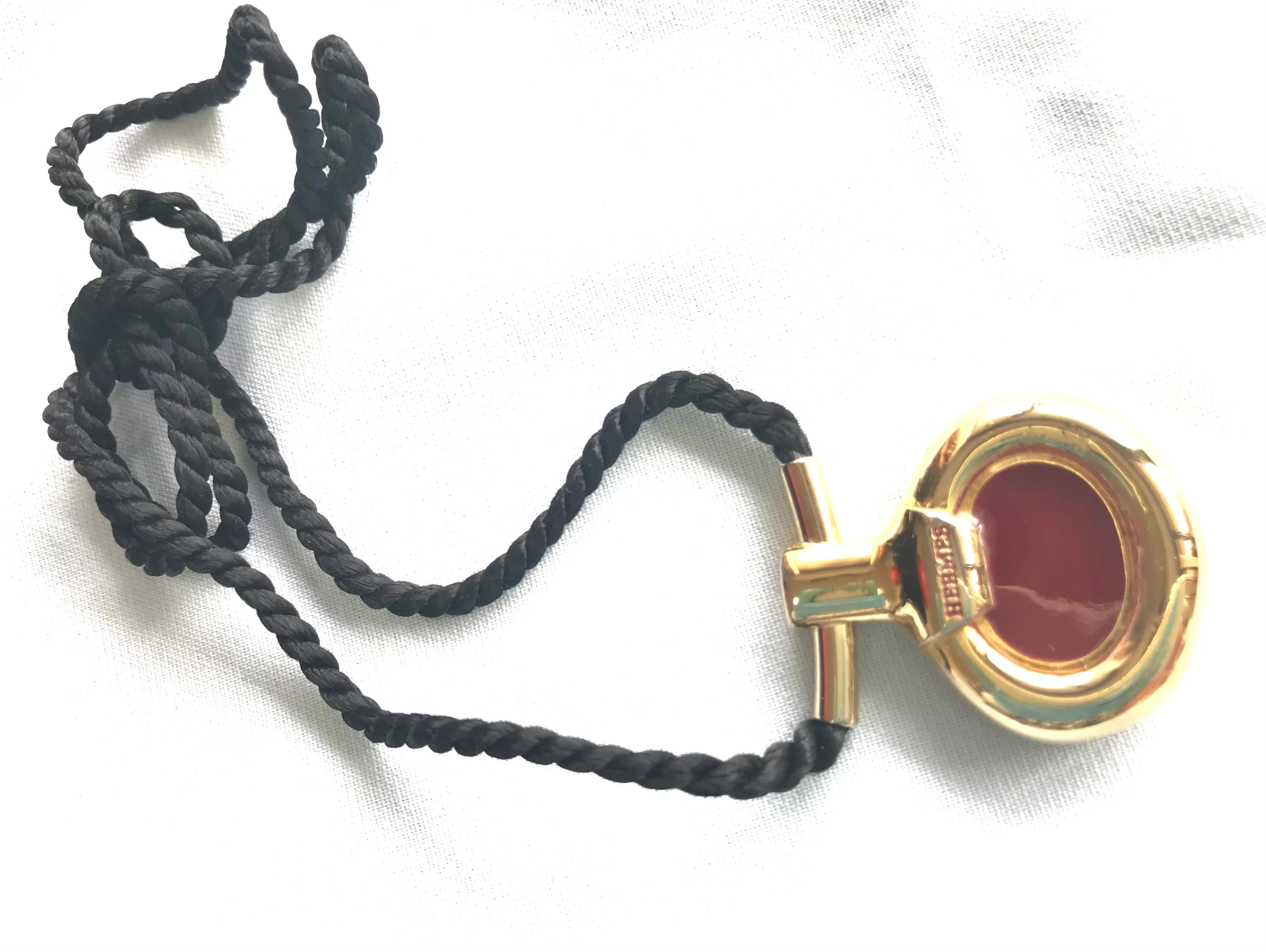 Vintage Hermes golden and red stone charm pendant top necklace with black strings. Unique jewel piece from PARFUM Collection. 060919re1